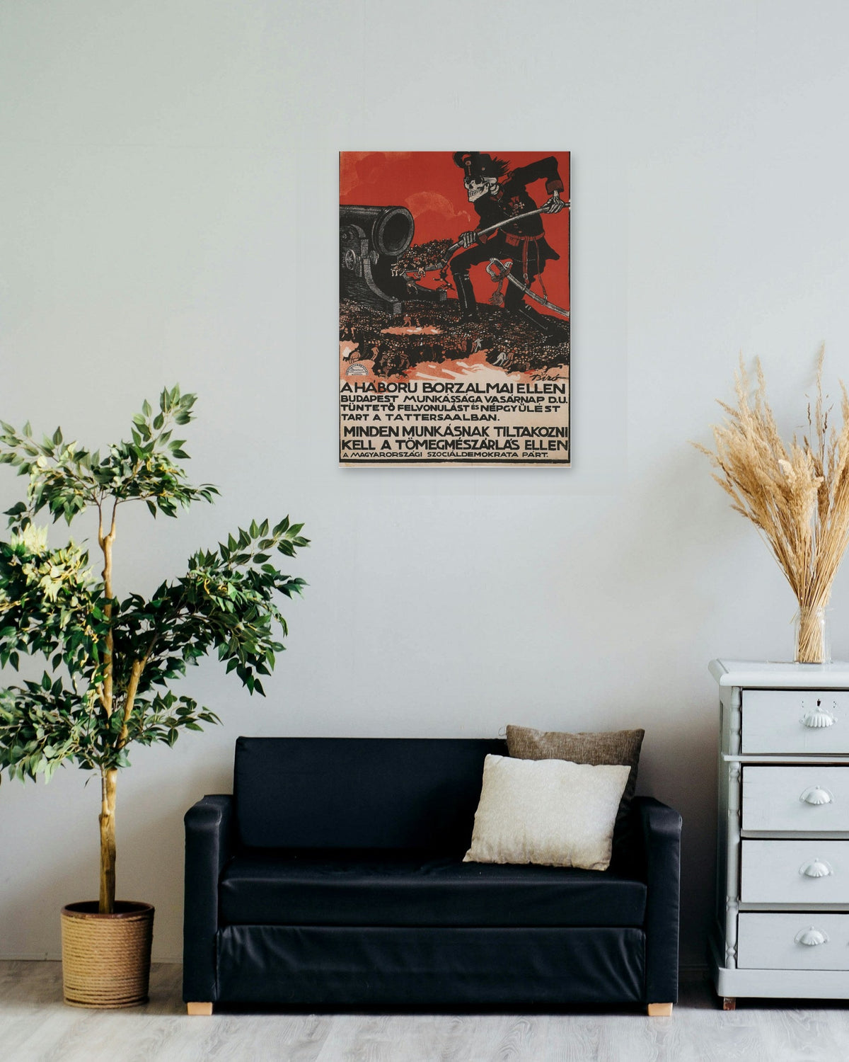 "A Háború Borzalmai Ellen" poster on a living room wall