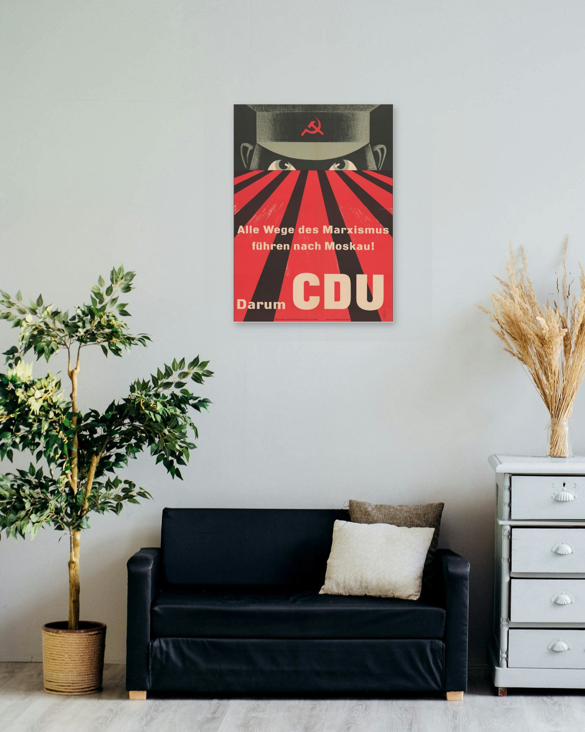 "All Roads of Marxism Lead to Moscow" poster on a living room wall