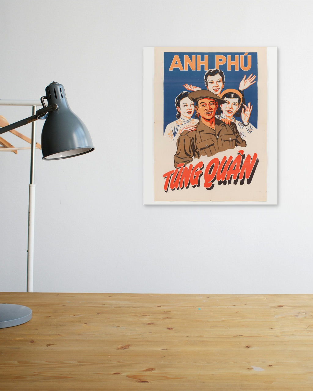 "Brother Phú Joins the Army" poster above a wooden desk