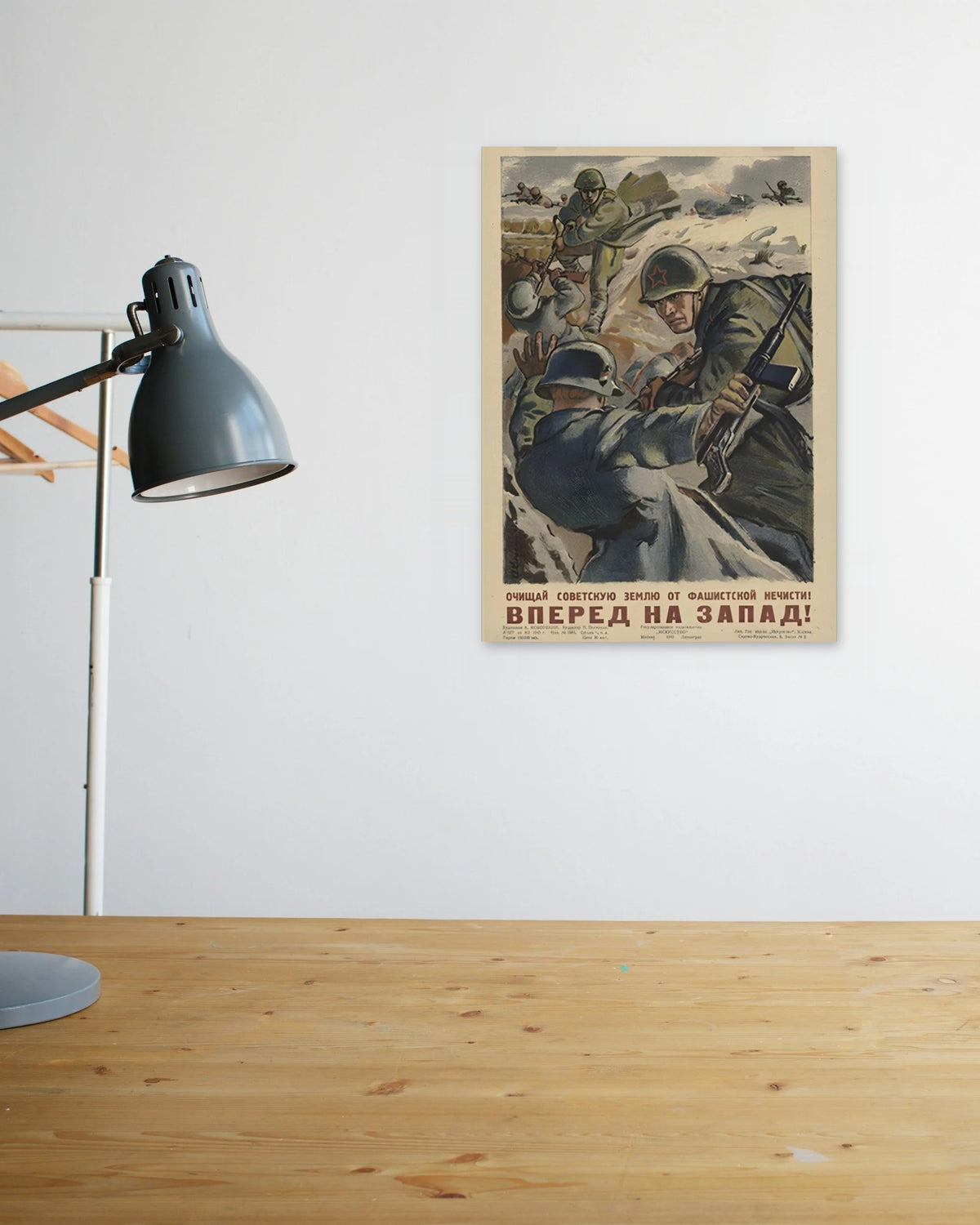 "Cleanse the Soviet Land of Fascist Filth" poster above a wooden desk