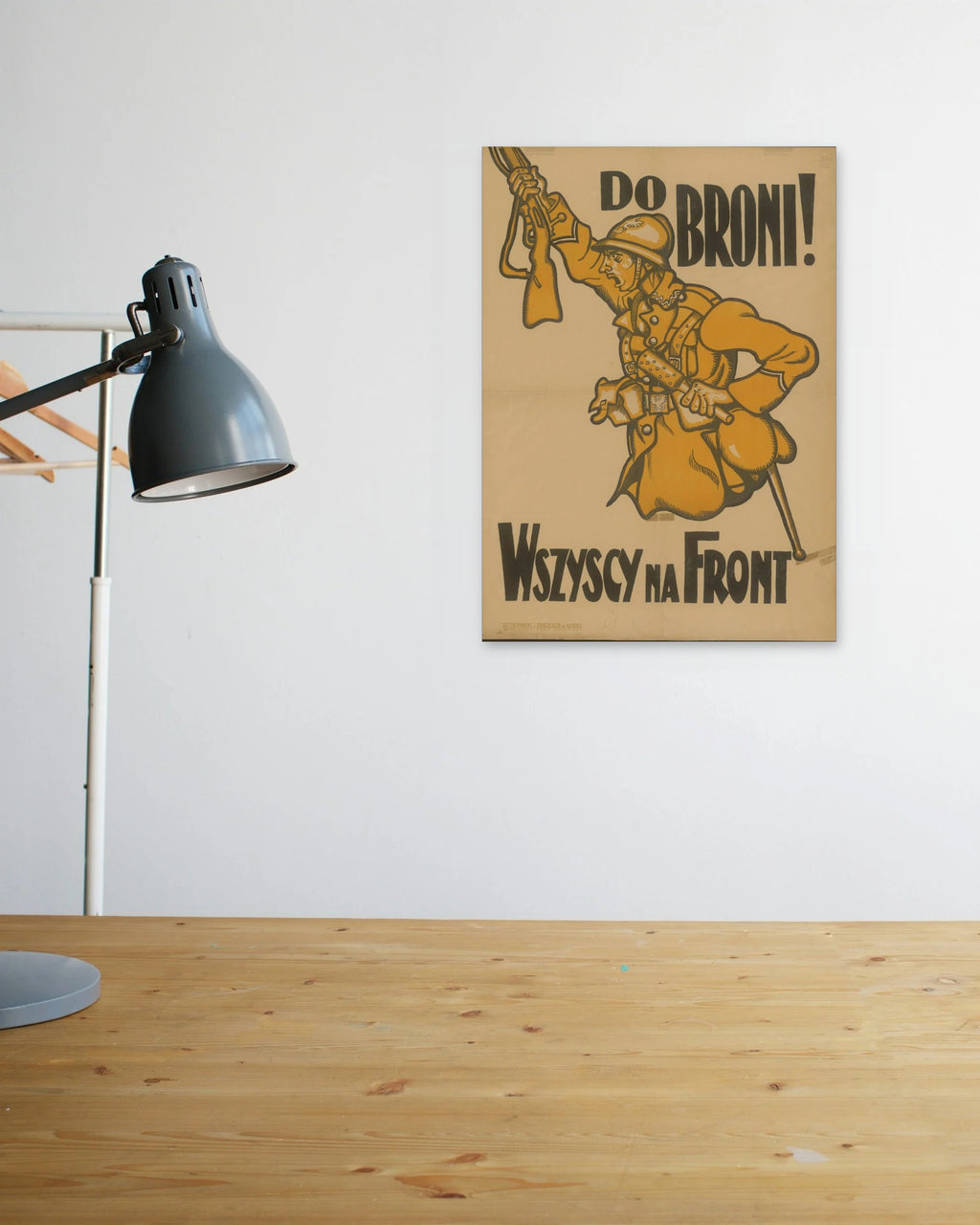 "Do Broni! Wszyscy na Front" poster above a wooden desk