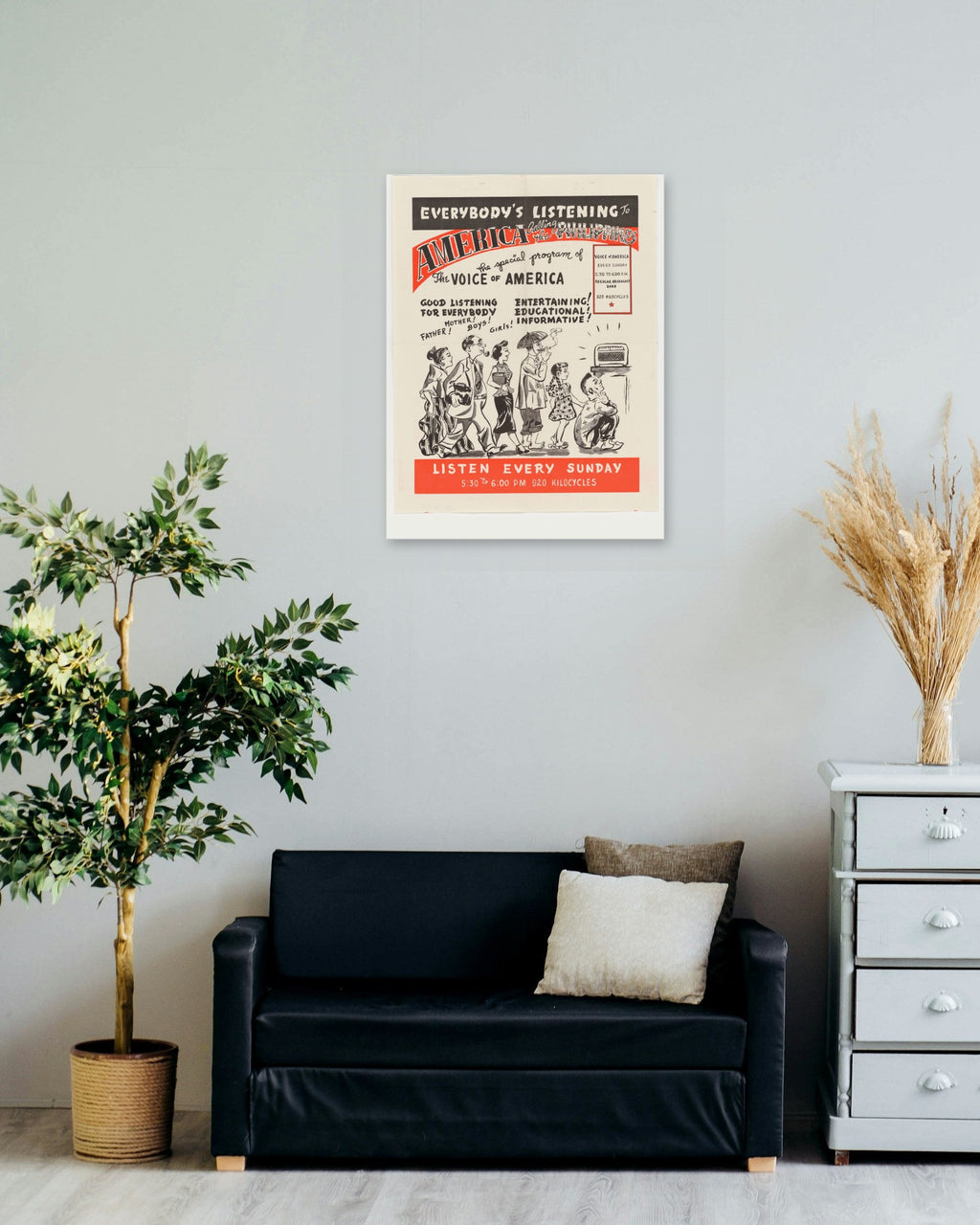 "Everybody's Listening to America!" poster on a living room wall