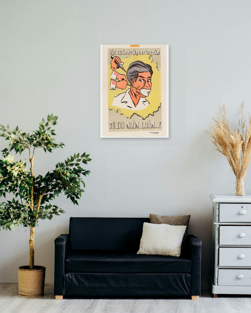 "Freedom of Speech in the Communist Paradise" poster on a living room wall