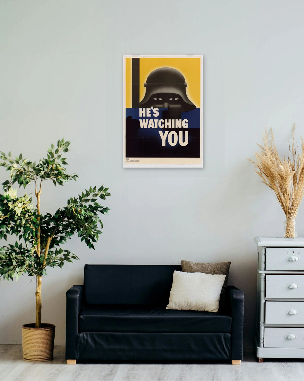 "He's Watching You" poster on a living room wall