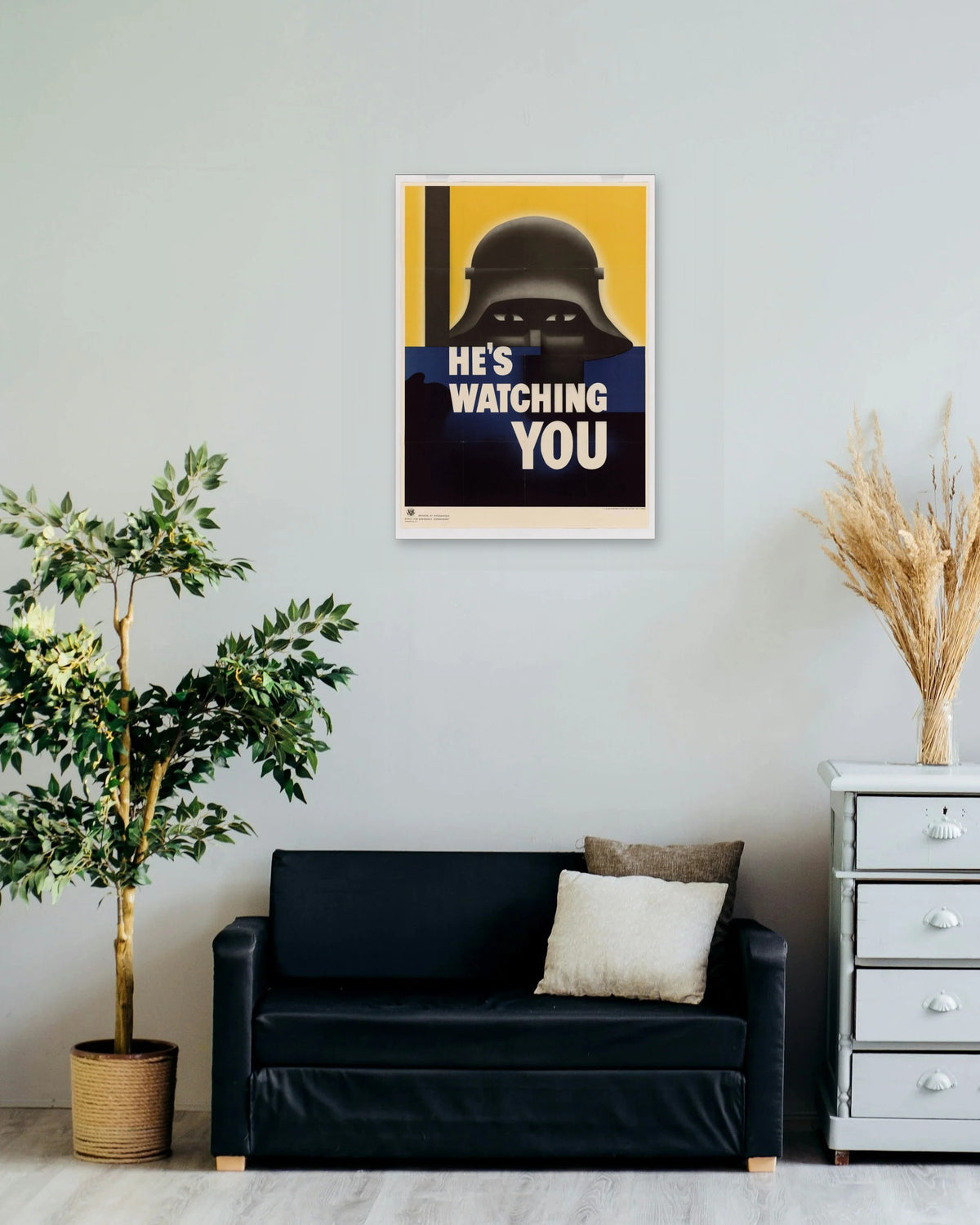 "He's Watching You" poster on a living room wall