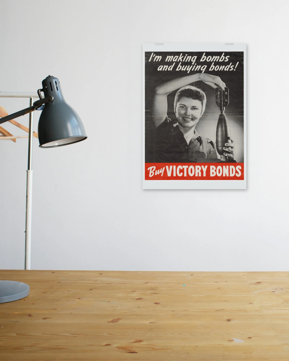 "I'm Making Bombs and Buying Bonds!" poster above a wooden desk