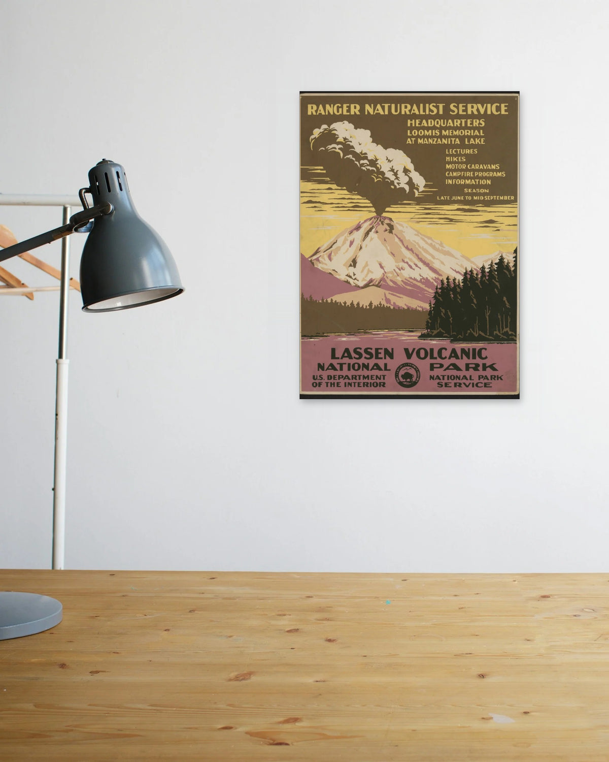 "Lassen Volcanic National Park" poster above a wooden desk