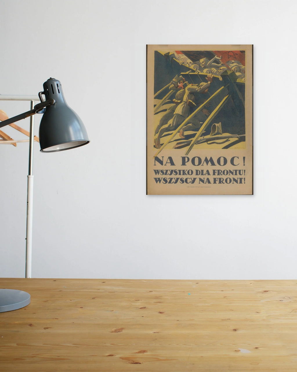 "Na Pomoc! Wszystko dla Frontu!" poster above a wooden desk