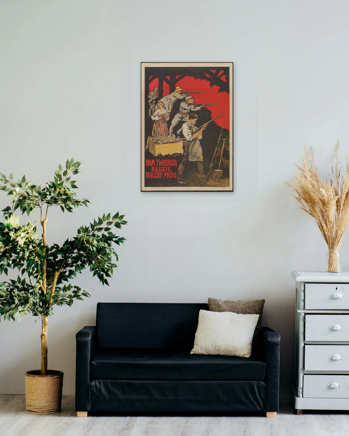"Nam Twierdzą Będzie Każdy Próg!" poster on a living room wall