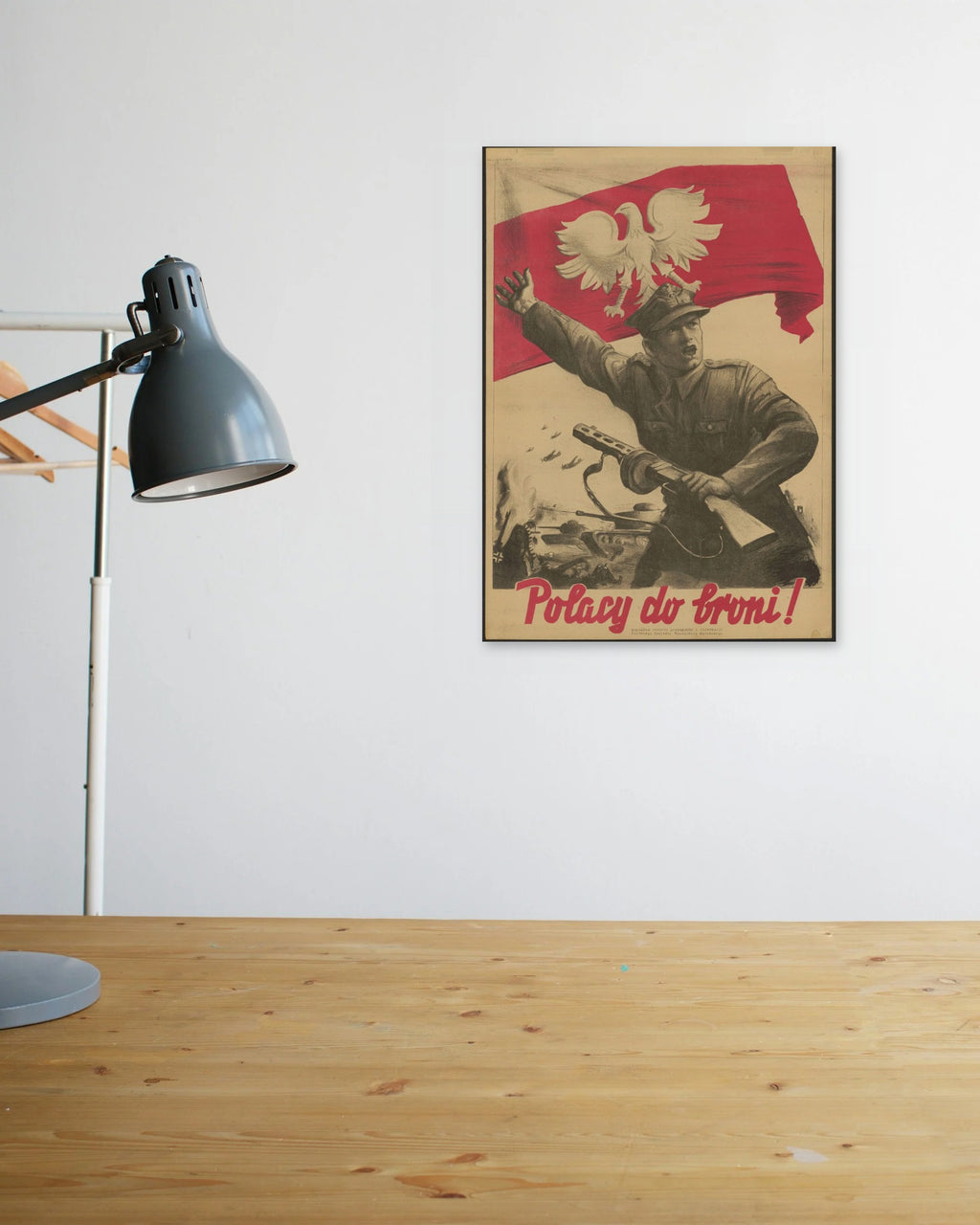 "Polacy do Broni!" poster above a wooden desk