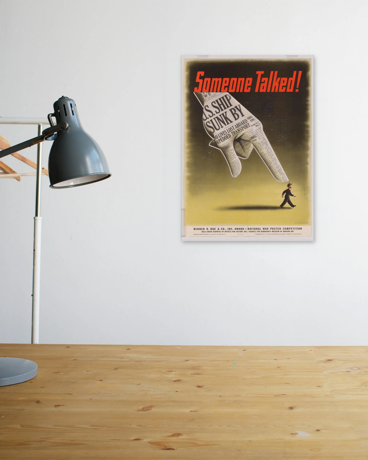"Someone Talked!" poster above a wooden desk