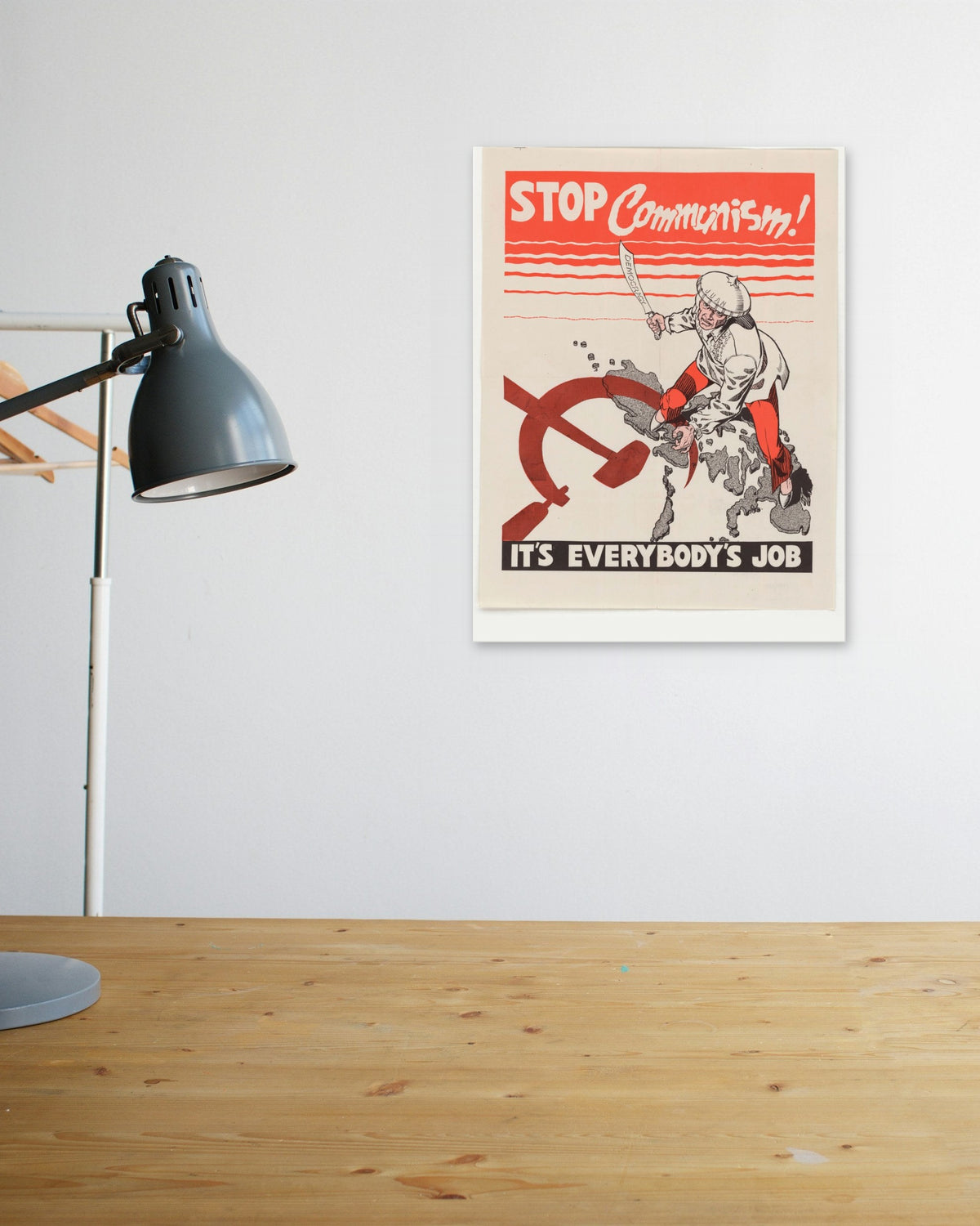 "Stop Communism! It's Everybody's Job" poster above a wooden desk