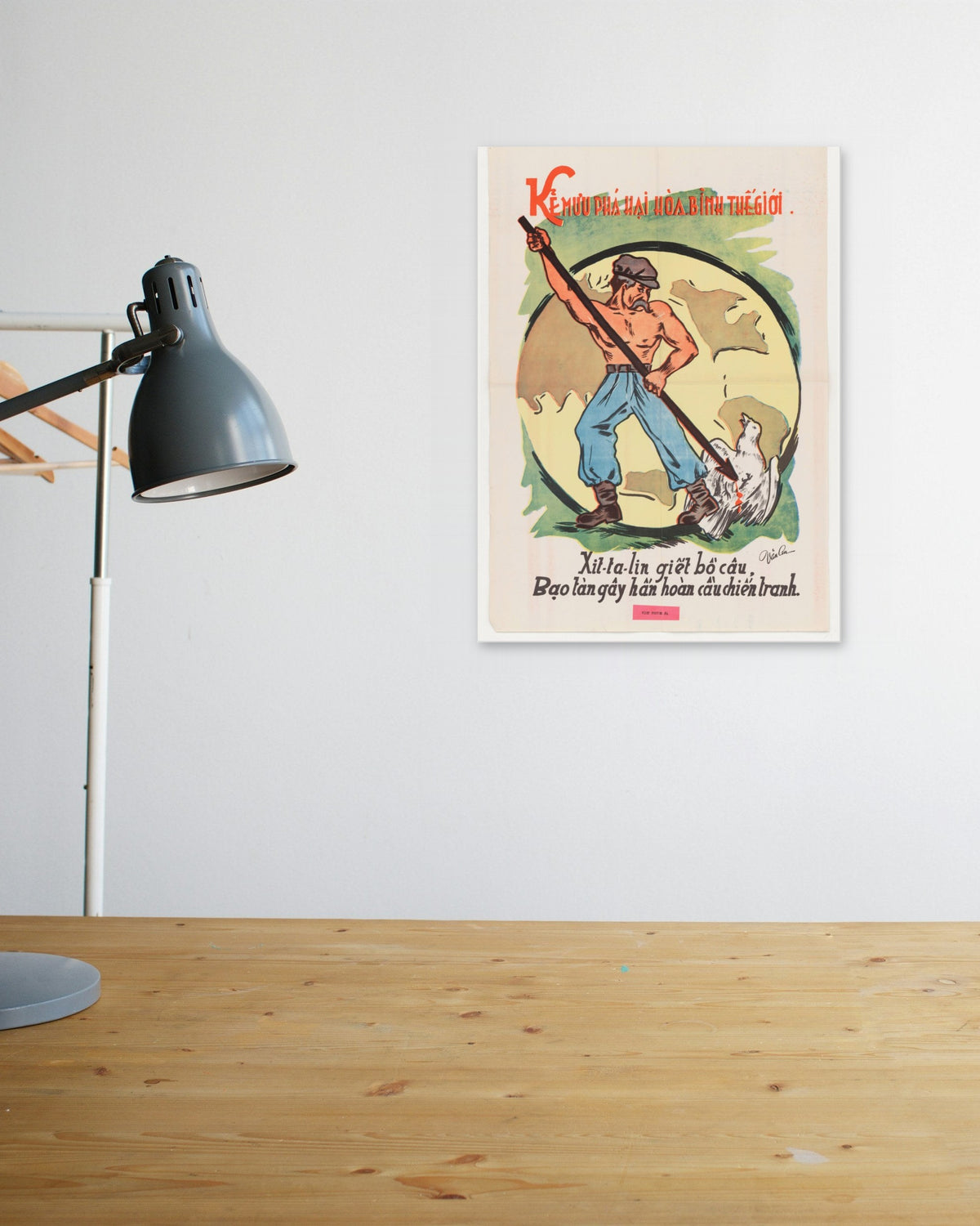 "The Destroyer of World Peace" poster above a wooden desk