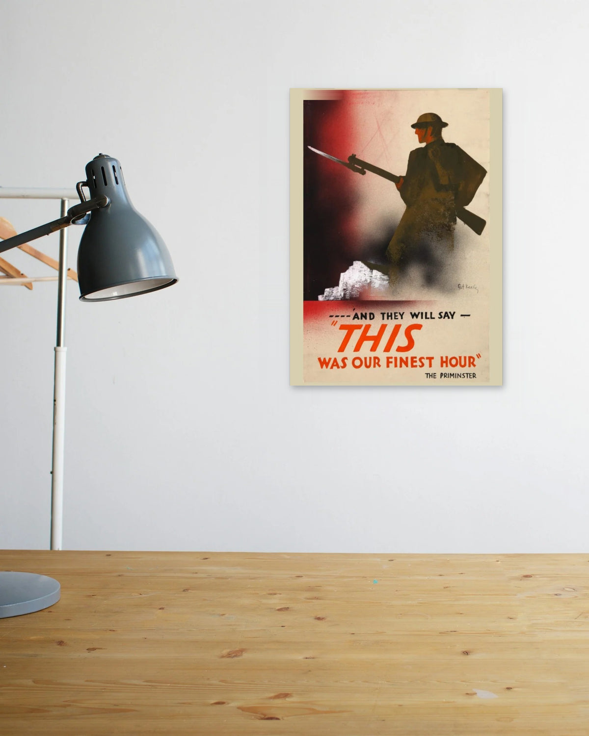 "This Was Their Finest Hour" poster above a wooden desk