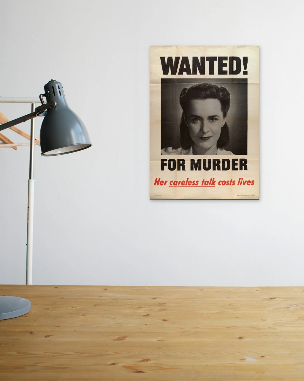 "Wanted! For Murder – Her Careless Talk Costs Lives" poster above a wooden desk