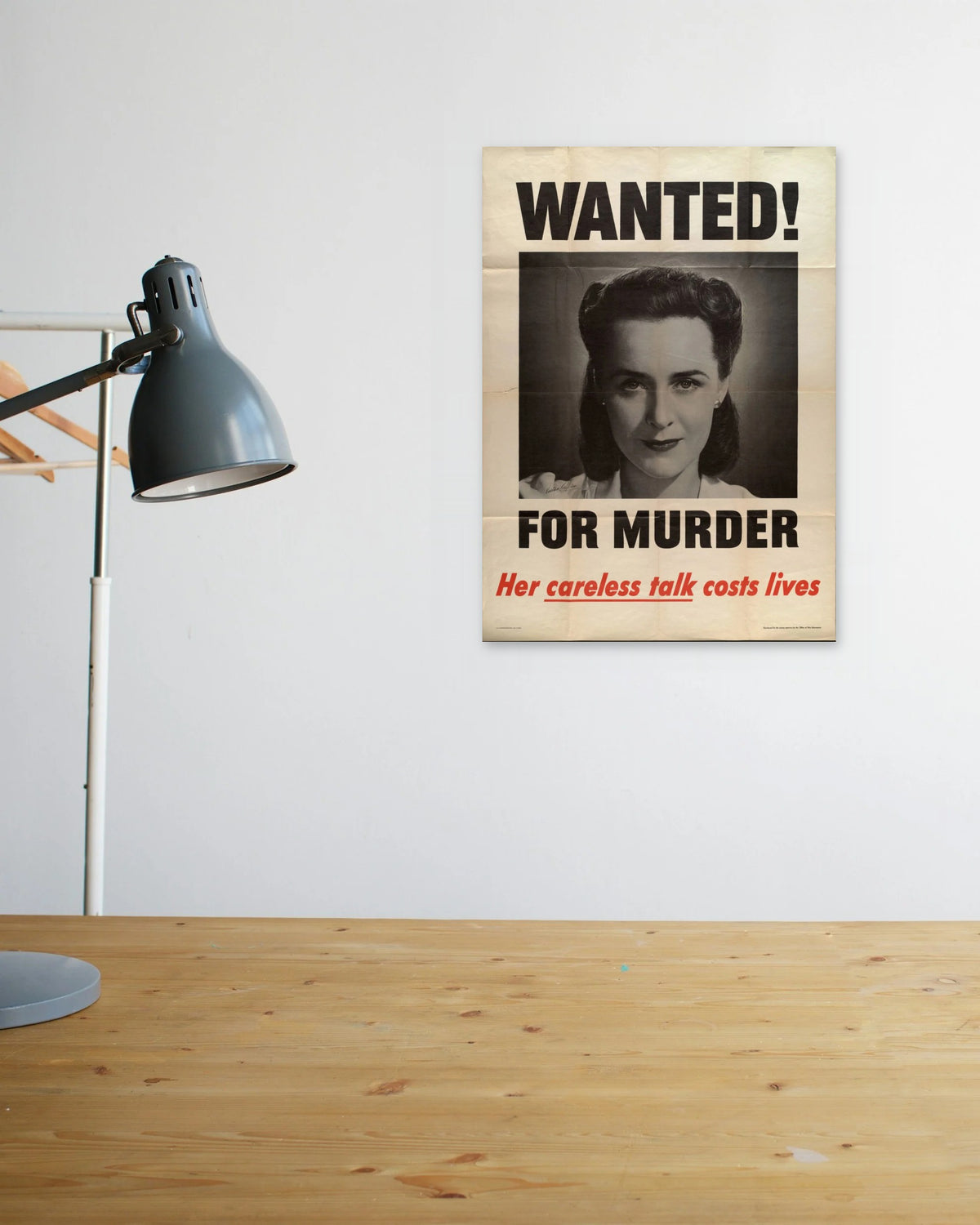 "Wanted! For Murder – Her Careless Talk Costs Lives" poster above a wooden desk