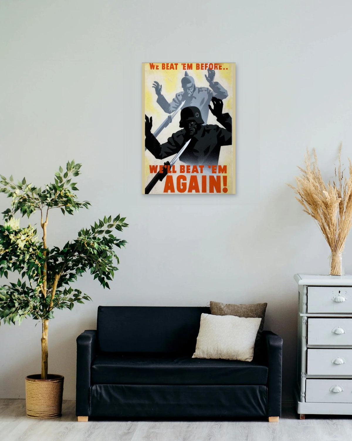 "We Beat 'em Before... We'll Beat 'em Again" poster on a living room wall