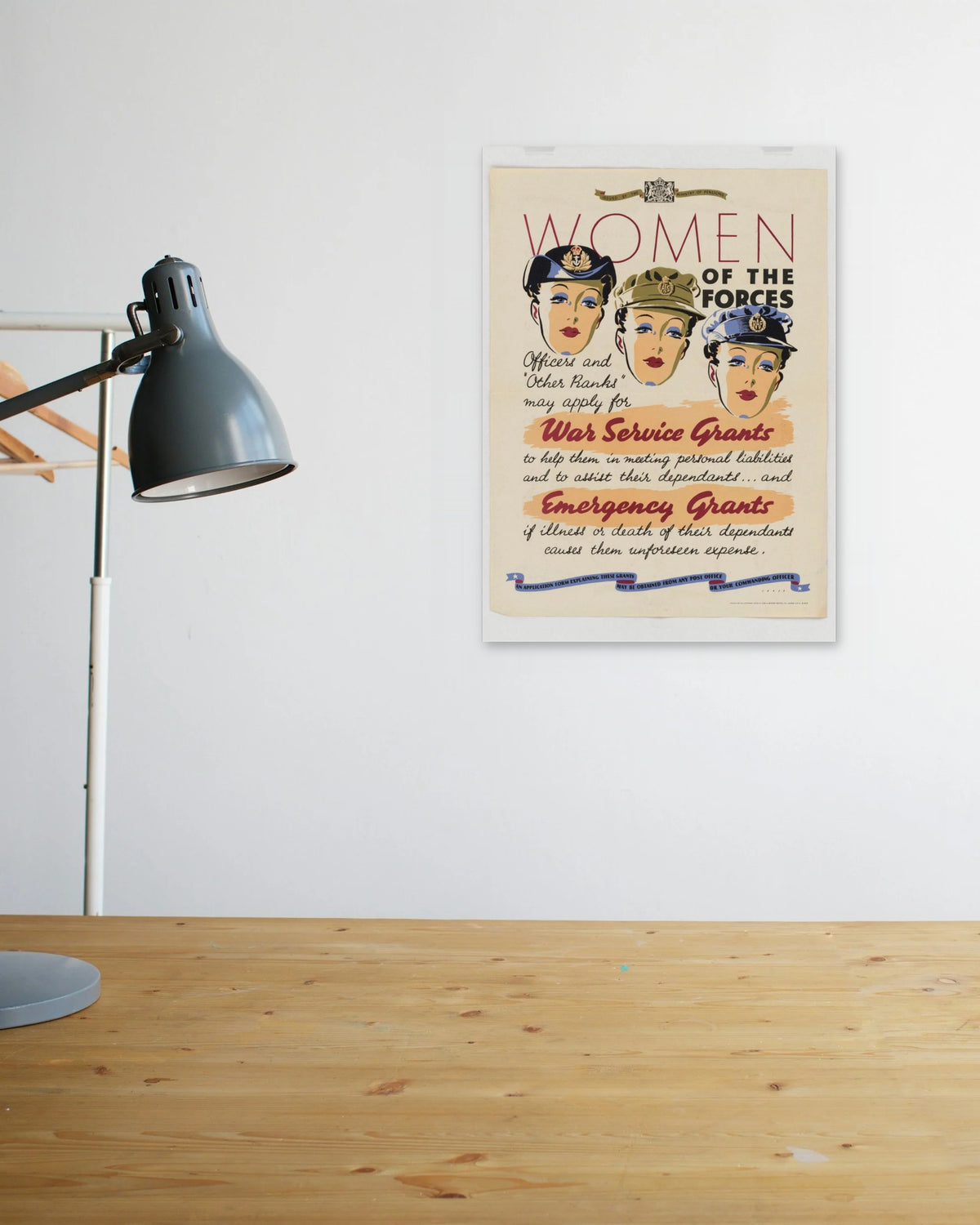 "Women of the Forces" poster above a wooden desk