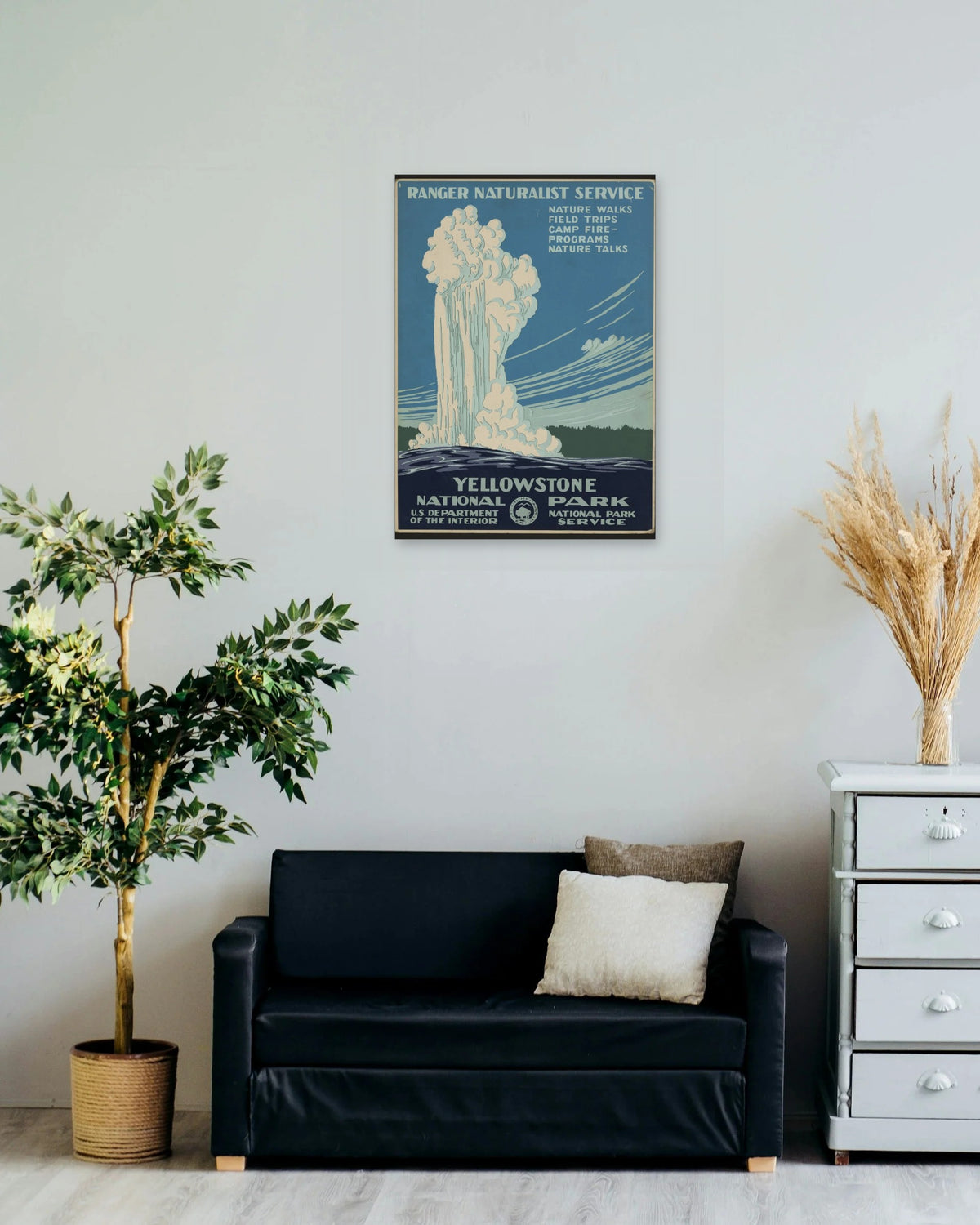 "Yellowstone National Park" poster on a living room wall