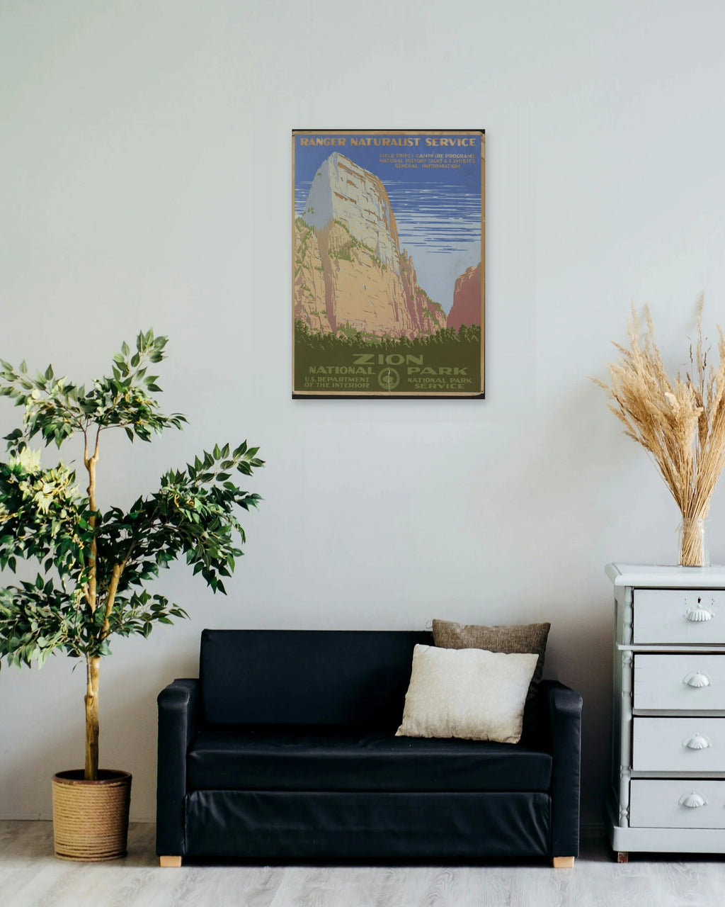 "Zion National Park" poster on a living room wall